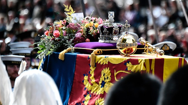 The coffin of Queen Elizabeth II, draped in the Royal Standard, rests on the State Gun Carriage as the funeral procession proceeds from Westminster Abbey to Wellington Arch in London, after the State Funeral of Queen Elizabeth II at Westminster Abbey on September 19, 2022 in London, England.