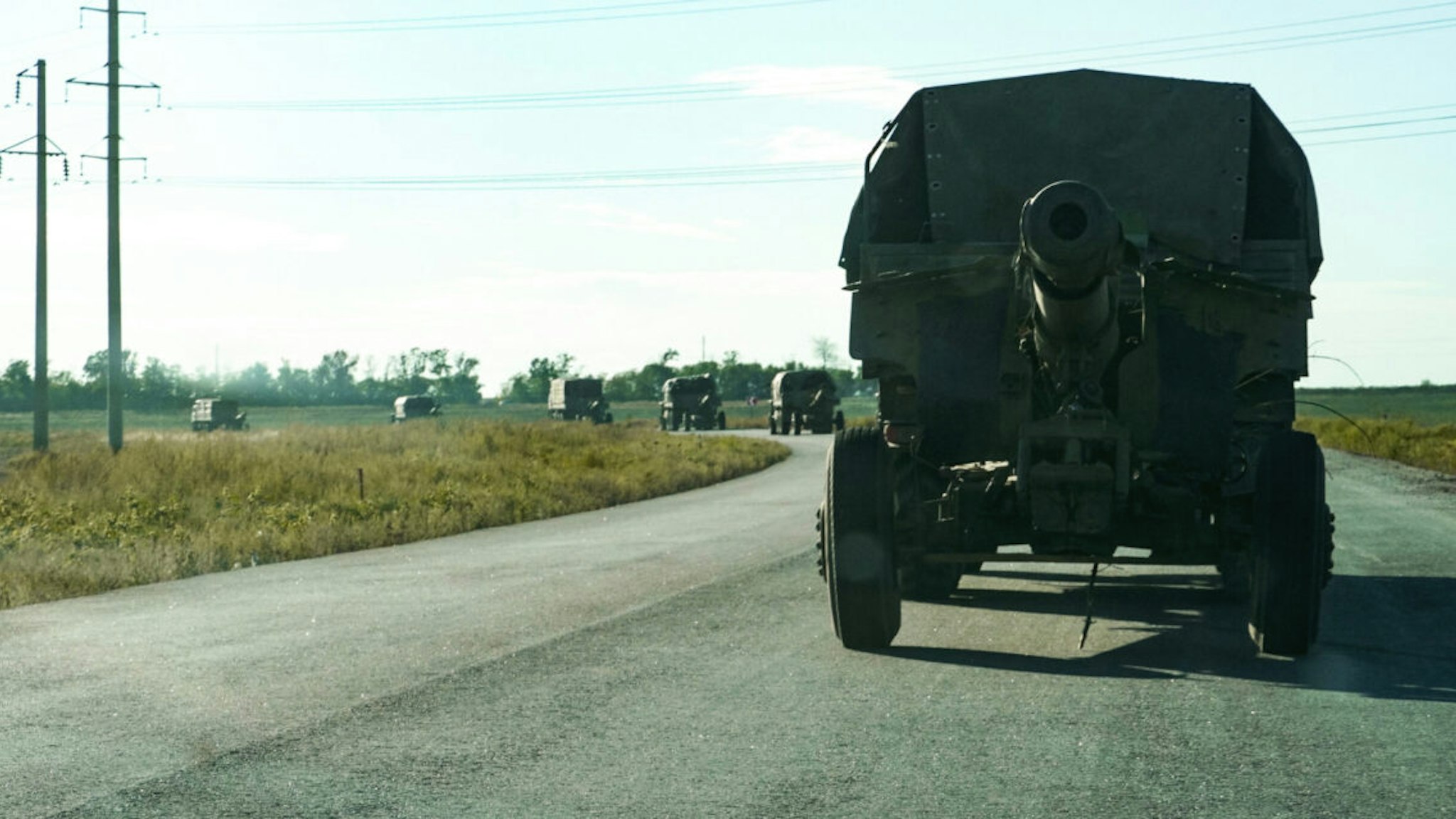 Russian military trucks tow artillery pieces on a road in the direction to the Zaporizhzhia region on September 8, 2022, amid the ongoing Russian military action in Ukraine