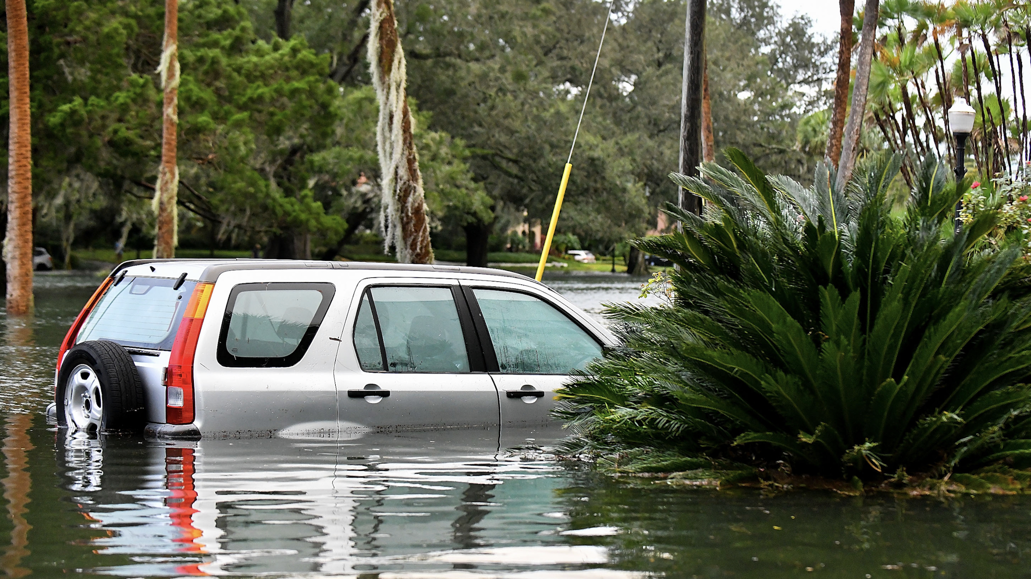 ORLANDO, FLORIDA - SEPTEMBER 29: A car sits in floodwater after Hurricane Ian on September 29, 2022 in Orlando, Florida. The hurricane brought high winds, storm surge and rain to the area causing severe damage.