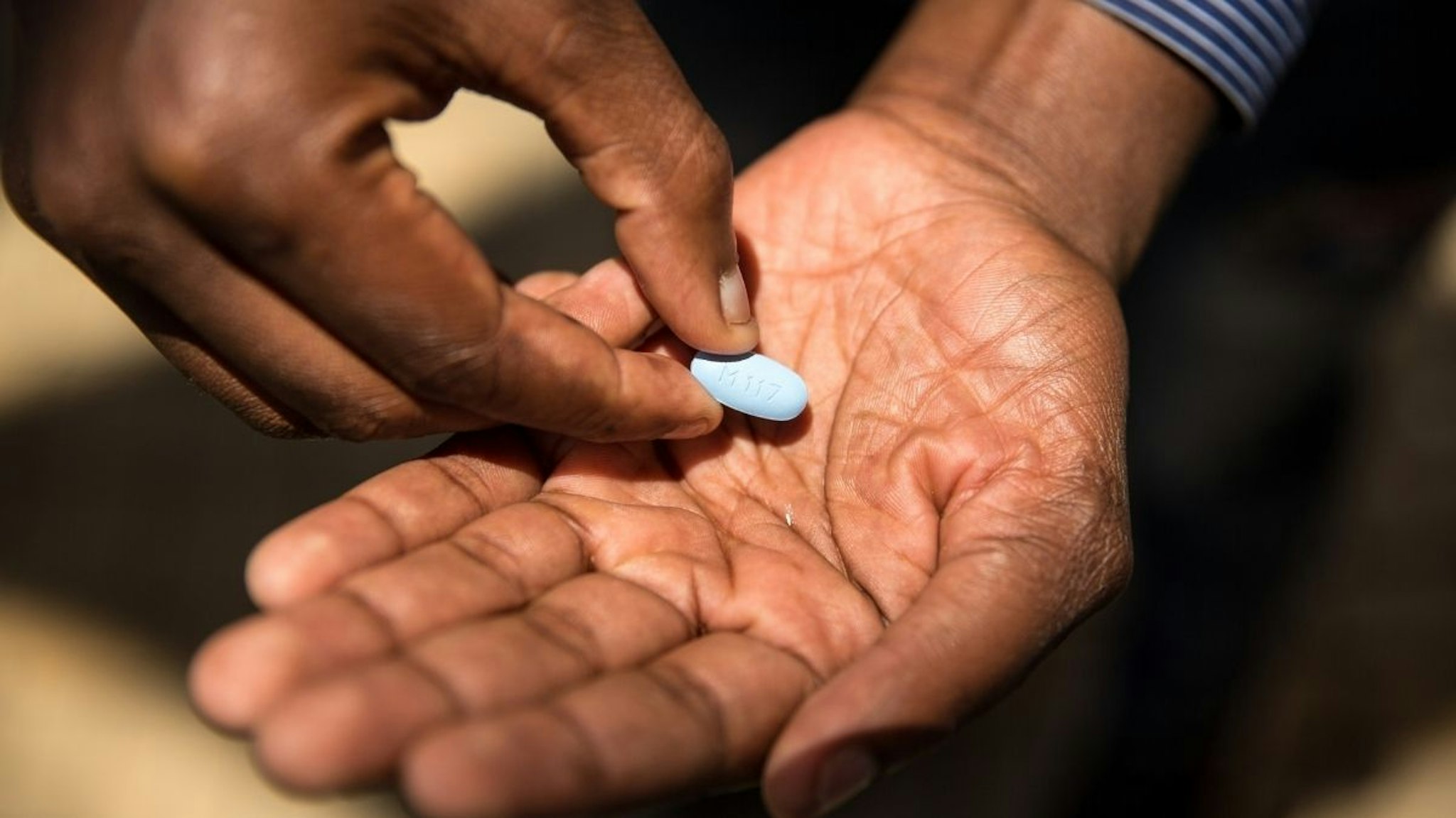 Thembelani Sibanda shows the Pre-Exposure Prophylaxis (PrEP), an HIV preventative drug during an interview on November 30, 2017 in Soweto, South Africa.