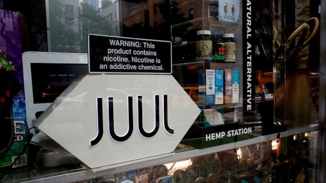 A Juul add is seen while as traffic is reflected at smoke shop on June 23, 2022 in New York.