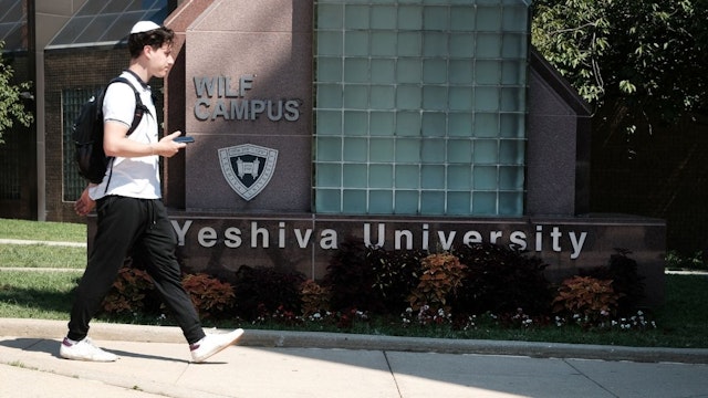 People walk by the campus of Yeshiva University in New York City on August 30, 2022 in New York City.