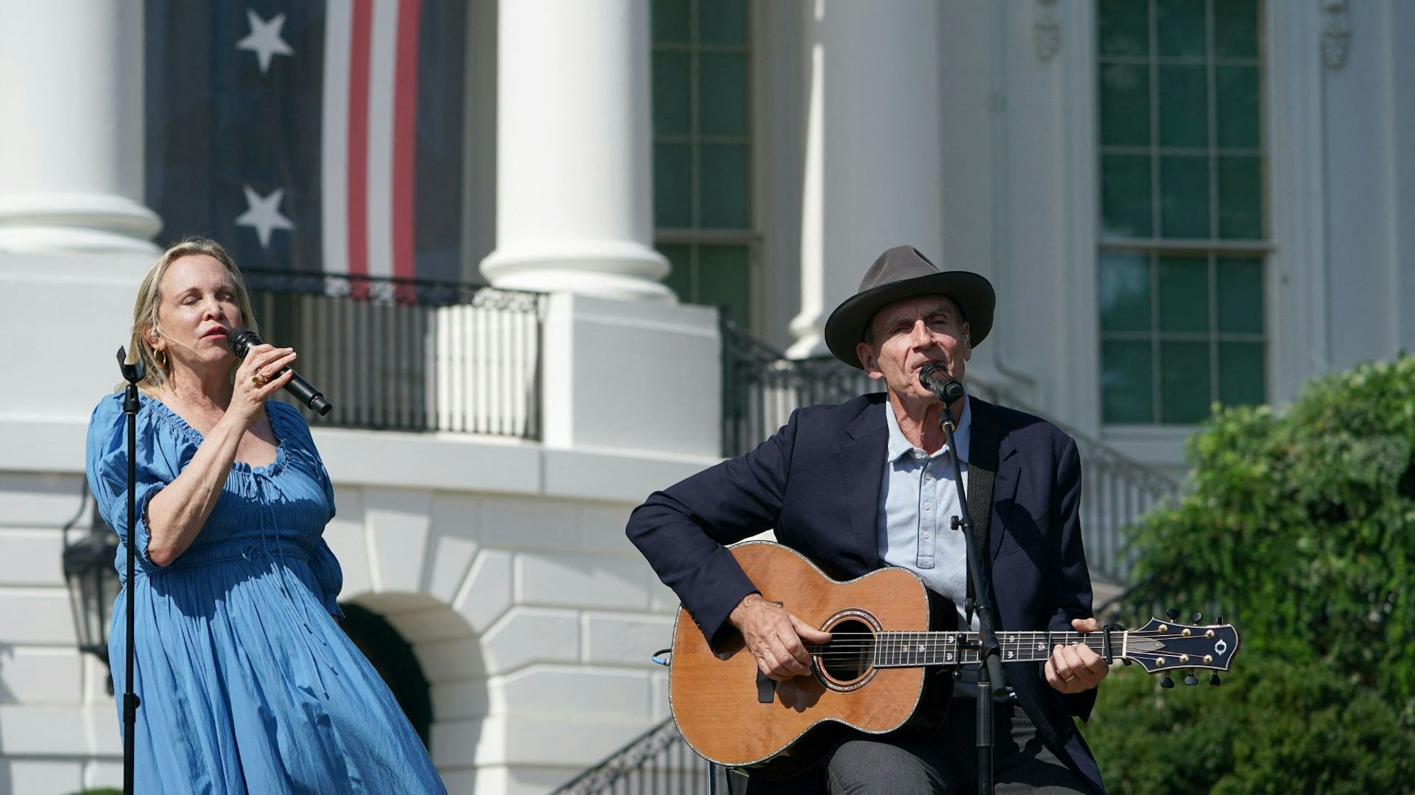 US singer James Taylor and wife Kim Taylor perform before US President Joe Biden speaks during an event to celebrate the passage of the Inflation Reduction Act of 2022 on the South Lawn of the White House in Washington, DC, on September 13, 2022.