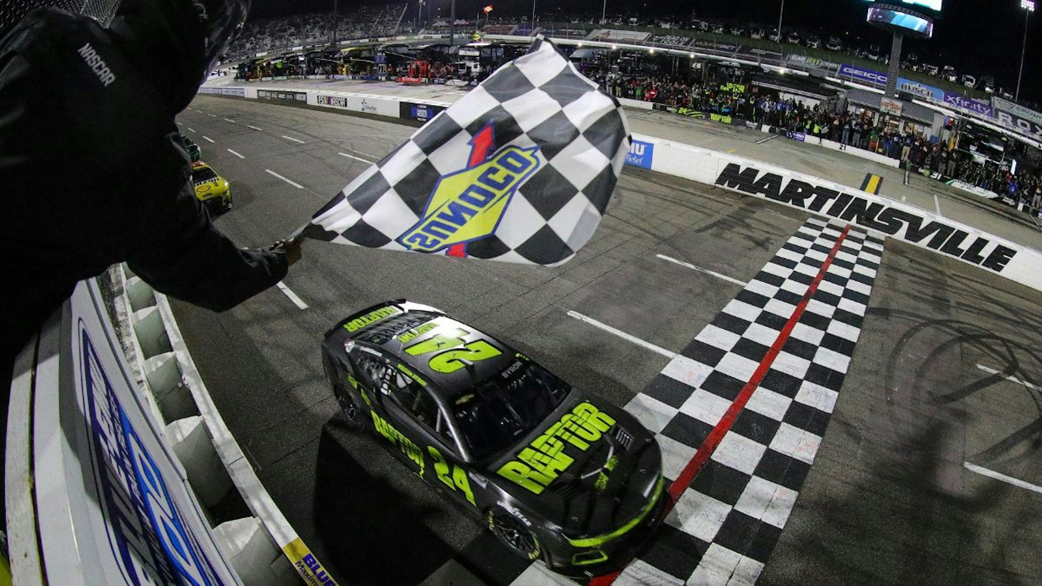 William Byron, driver of the #24 RaptorTough.com Chevrolet, takes the checkered flag to win the NASCAR Cup Series Blue-Emu Maximum Pain Relief 400 at Martinsville Speedway on April 09, 2022 in Martinsville, Virginia.