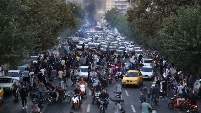 A picture obtained by AFP outside Iran on September 21, 2022, shows Iranian demonstrators taking to the streets of the capital Tehran during a protest for Mahsa Amini, days after she died in police custody.