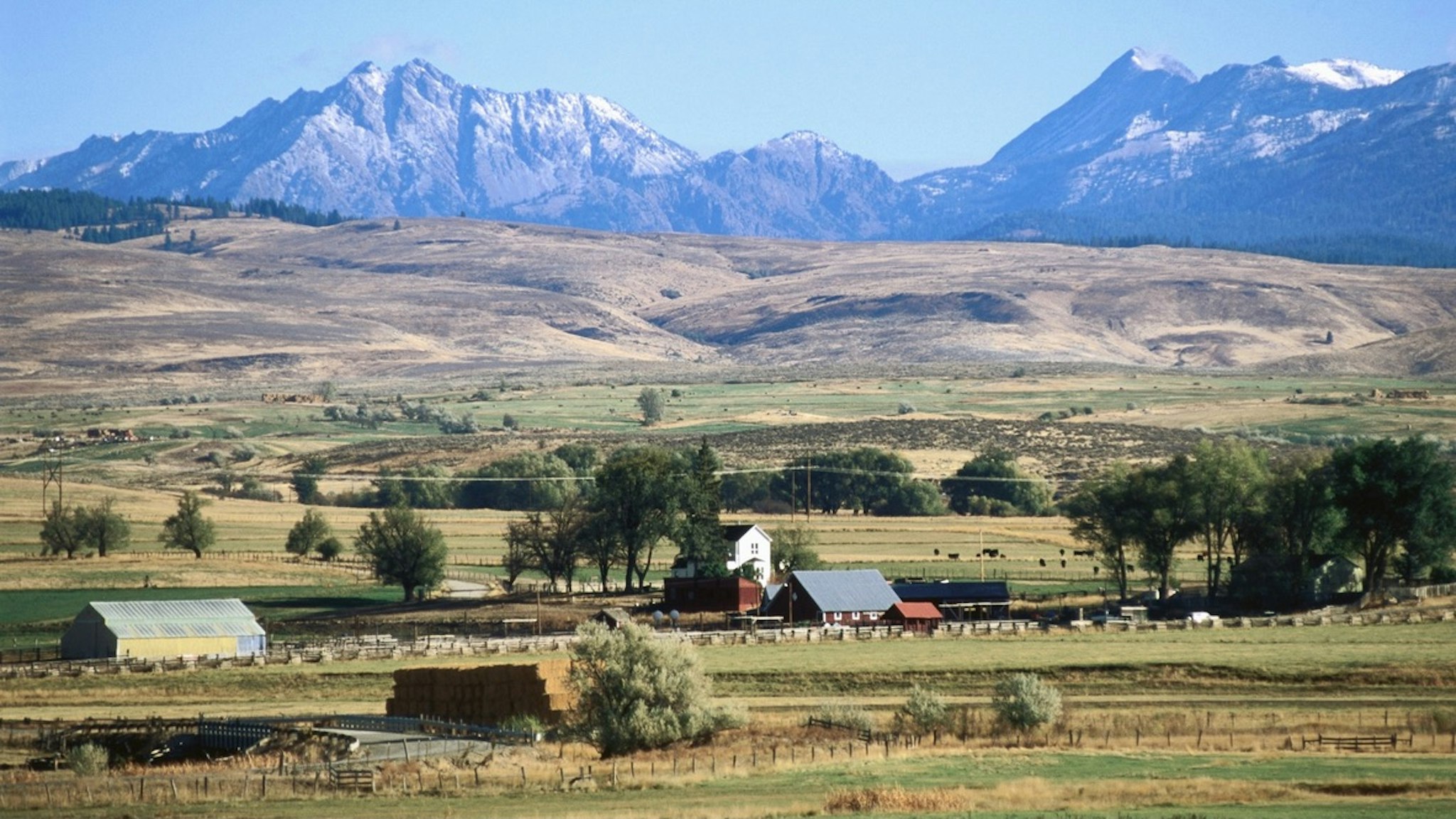 Farm and Wallowa Mountains, Powder River Valley. - stock photo Joseph, Oregon, United States, North America John Elk via Getty Images