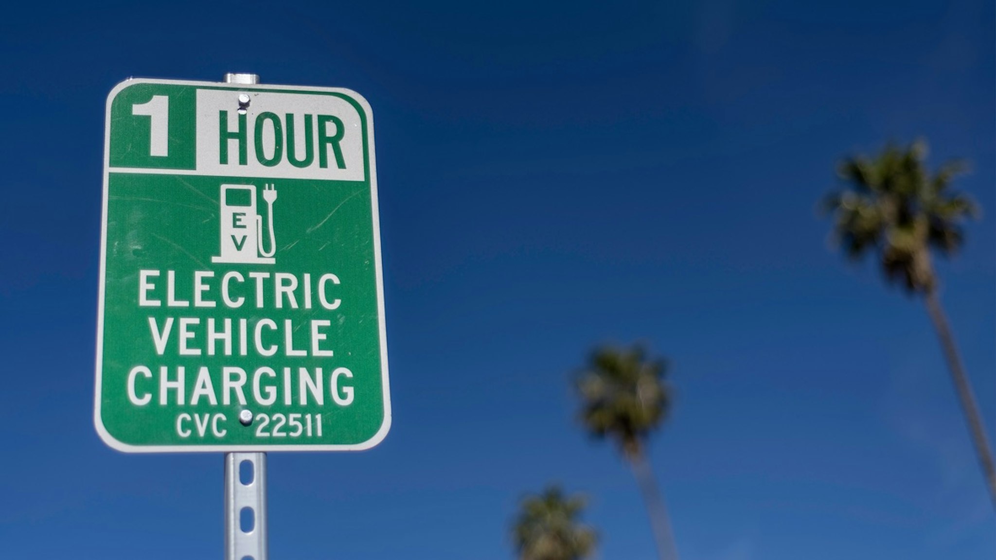 Electric Car Charging Station Sign - stock photo Electric vehicle charging station sign, Los Angeles, CA. GDMatt66 via Getty Images