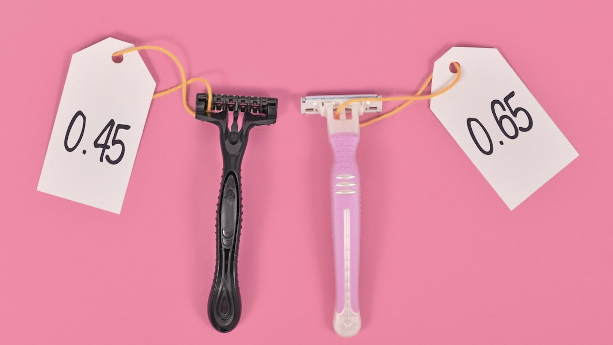 Pink Tax concept - stock photo Concept for pink tax showing pink and black razor aimed at specific genders with different price tags Firn via Getty Images
