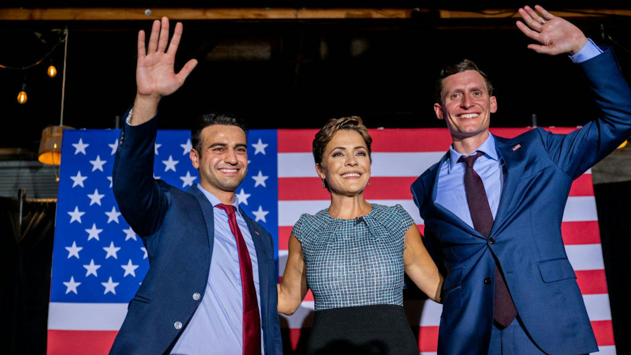 Abraham Hamadeh, Kari Lake, Blake Masters PHOENIX, ARIZONA - AUGUST 01: (L-R) Republican candidate for state attorney general Abraham Hamadeh, Republican gubernatorial candidate Kari Lake, and Republican U.S. senatorial candidate Blake Masters wave to supporters at the conclusion of a campaign event on the eve of the primary at the Duce bar on August 01, 2022 in Phoenix, Arizona. Lake, who has the endorsement of former President Donald Trump, is facing Karrin Taylor Robson, who is being backed by former Vice President Mike Pence. (Photo by Brandon Bell/Getty Images)