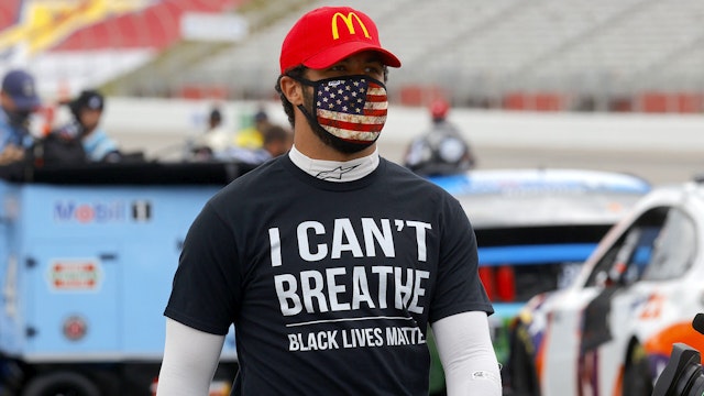 HAMPTON, GEORGIA - JUNE 07: Bubba Wallace, driver of the #43 McDonald's Chevrolet, wears a "I Can't Breathe - Black Lives Matter" T-shirt under his fire suit in solidarity with protesters around the world taking to the streets after the death of George Floyd on May 25 while in the custody of Minneapolis, Minnesota police on the grid prior to the NASCAR Cup Series Folds of Honor QuikTrip 500 at Atlanta Motor Speedway on June 07, 2020 in Hampton, Georgia.