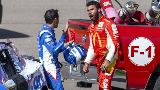 LAS VEGAS, NV - OCTOBER 16: Bubba Wallace (#45 23XI Racing MoneyLion Toyota) yells at Kyle Larson (#5 Hendrick Motorsports HendrickCars.com Chevrolet) after they wrecked in the tri-oval before turn 1 during the NASCAR Cup Series Playoff South Point 400 on October 16, 2022, at Las Vegas Motor Speedway in Las Vegas, NV.