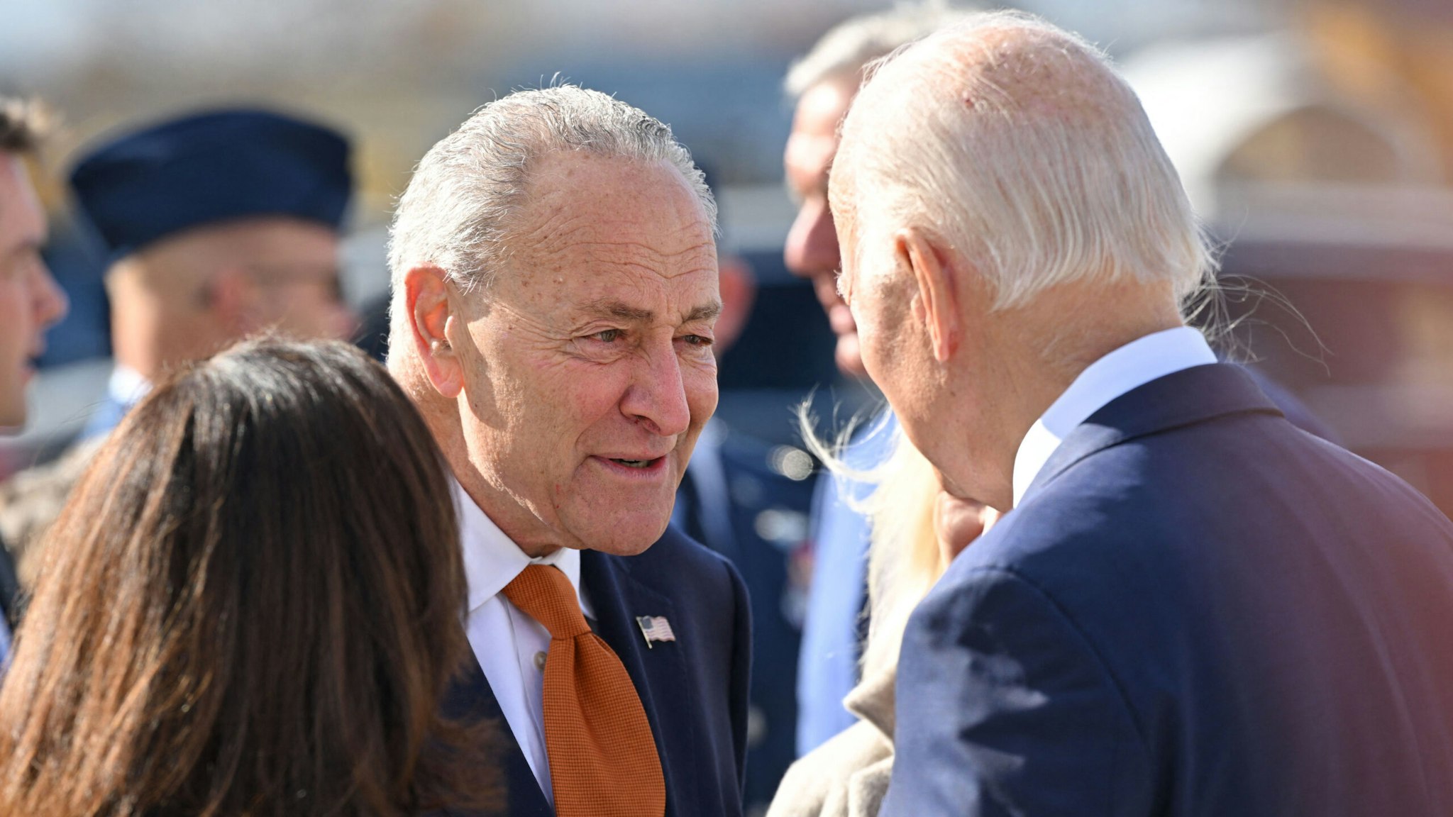 US President Joe Biden(R) is greeted by US Senate Majority Leader Chuck Schumer (C) and New York Governor Kathy Hochul (L) as Biden arrives at Hancock International Airport in Syracuse, New York, on October 27, 2022.