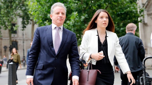 Former UK intelligence officer Christopher Steele (L) arrives at the High Court in London on July 24, 2020, to attend his defamation trial brought by Russian tech entrepreneur Alexej Gubarev. - A Russian tech entrepreneur on Monday began a defamation claim against the British author of a controversial report at the heart of 2016 US election meddling allegations first leaked to BuzzFeed. Alexej Gubarev said in documents released in London's High Court that former UK intelligence officer Christopher Steele was responsible for the US news site's January 2017 publication of his dossier. (Photo by Tolga AKMEN / AFP) (Photo by TOLGA AKMEN/AFP via Getty Images)