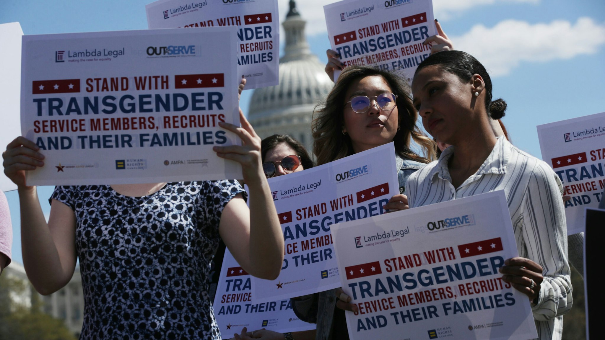 Activists participate in a rally at the Reflecting Pool of the U.S. Capitol April 10, 2019 in Washington, DC. Democratic lawmakers joined activists to rally against the transgender military service ban.