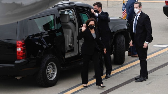 US Vice President Kamala Harris waves as she steps out of her motorcade to board Air Force Two at Metro Oakland International Airport (OAK) on April 5, 2021 in Oakland, California. (Photo by