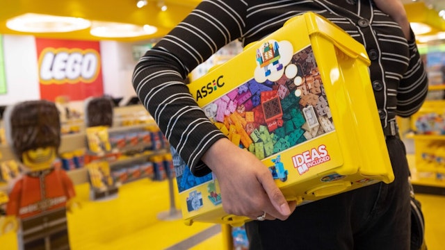 A customer carries a box from the Classic Lego range at the Lego A/S store in London, U.K., on Monday, March 7, 2022.