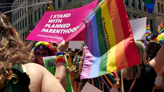 An attendee holds a sign supporting Planned Parenthood during the NYC Pride March in New York, U.S., on Sunday, June 26, 2022. New York Citys annual Pride March commemorates the 1969 uprising by members of the LGBTQ community at the Stonewall Inn in Greenwich Village. Photographer: Gabby Jones/Bloomberg via Getty Images