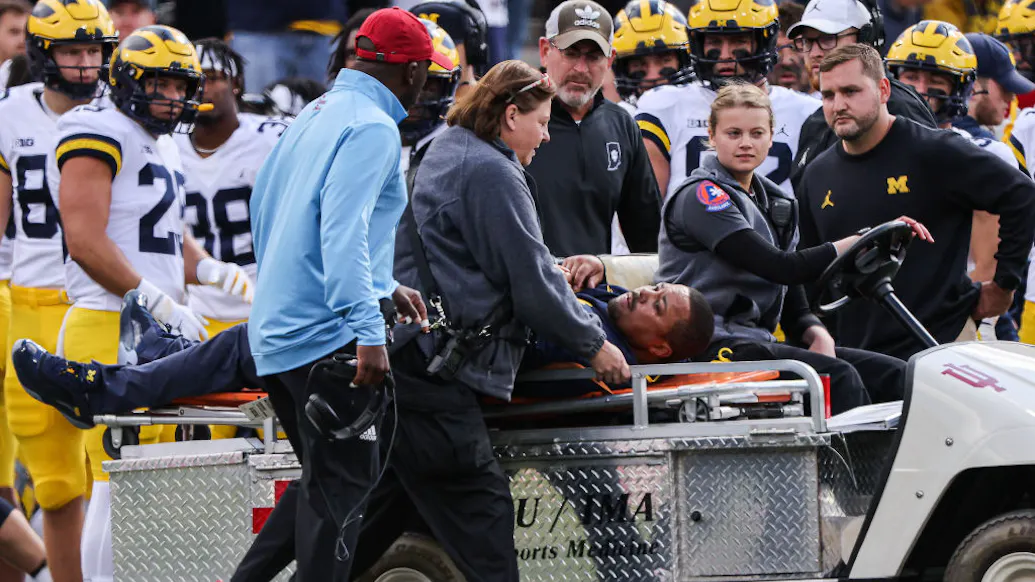 Michigan Football Coach, Former NFL Player Collapses On Sideline During Game, Carted Off Field