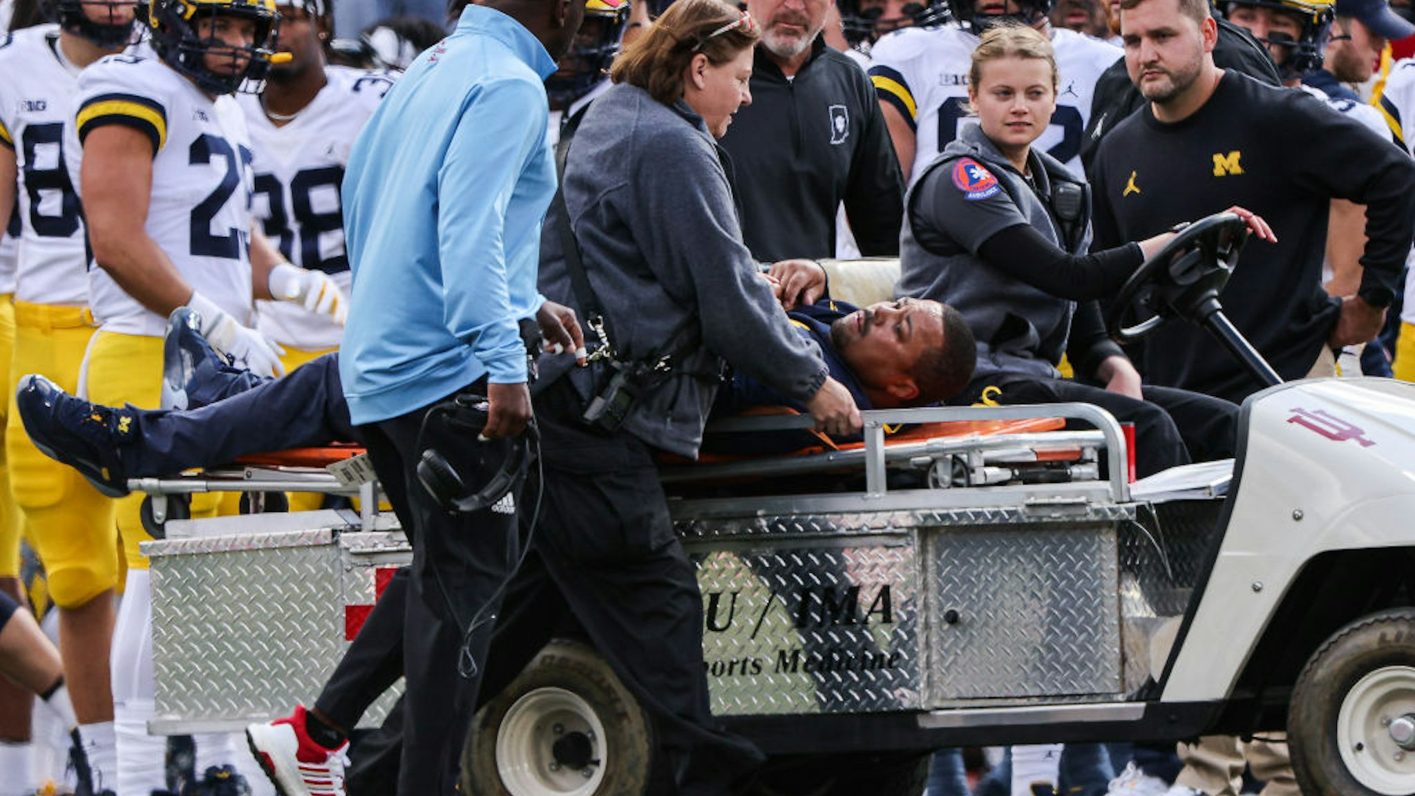 BLOOMINGTON, IN - OCTOBER 08: Michigan Wolverines running back coach Mike Hart is carted off of the field during the first half against the Indiana Hoosiers at Memorial Stadium on October 8, 2022 in Bloomington, Indiana.