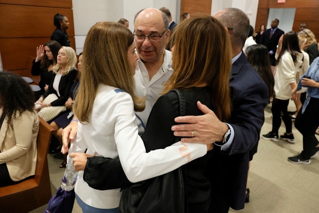 Linda Beigel Schulman, Michael Schulman, Patricia Padauy Oliver and Fred Guttenberg, family members of the victims, hug inside the courtroom for an expected verdict in the penalty phase of the trial of Marjory Stoneman Douglas High School shooter Nikolas Cruz at the Broward County Courthouse in Fort Lauderdale, Florida on October 13, 2022. - Cruz, who shot and killed 17 people at a Florida high school in 2018, planned and carried out a "systematic massacre," a prosecutor arguing for the death penalty said Tuesday.