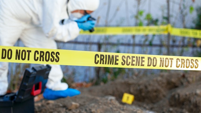 Crime scene investigation. Forensic science specialist working on human remains identification. - stock photo