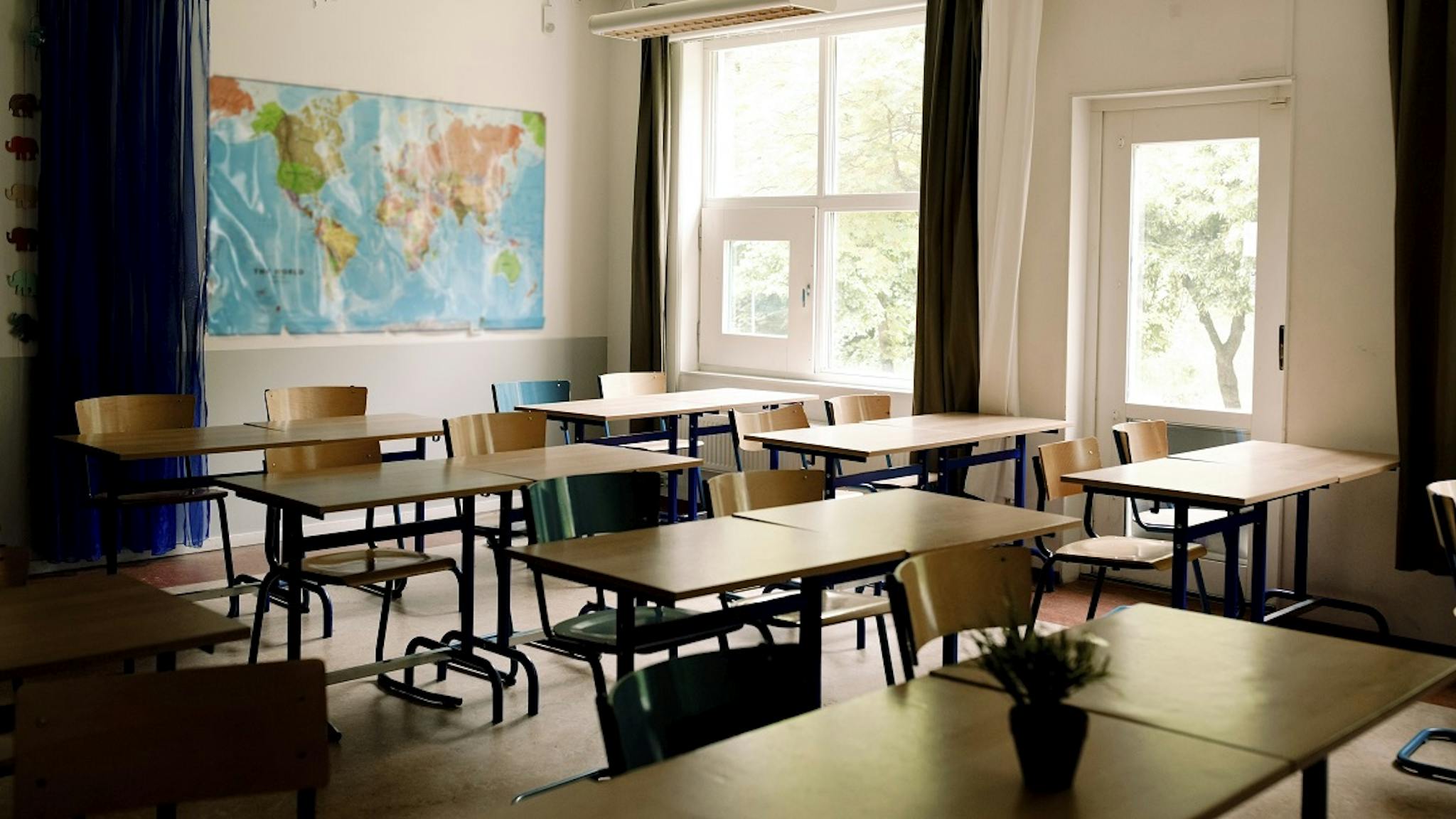 Desks and chairs arranged in classroom at high school