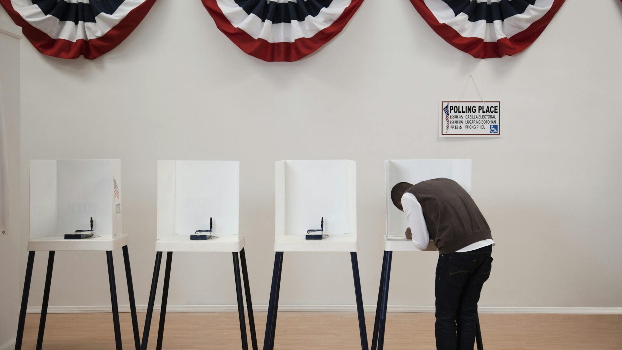 Hispanic voter voting in polling place