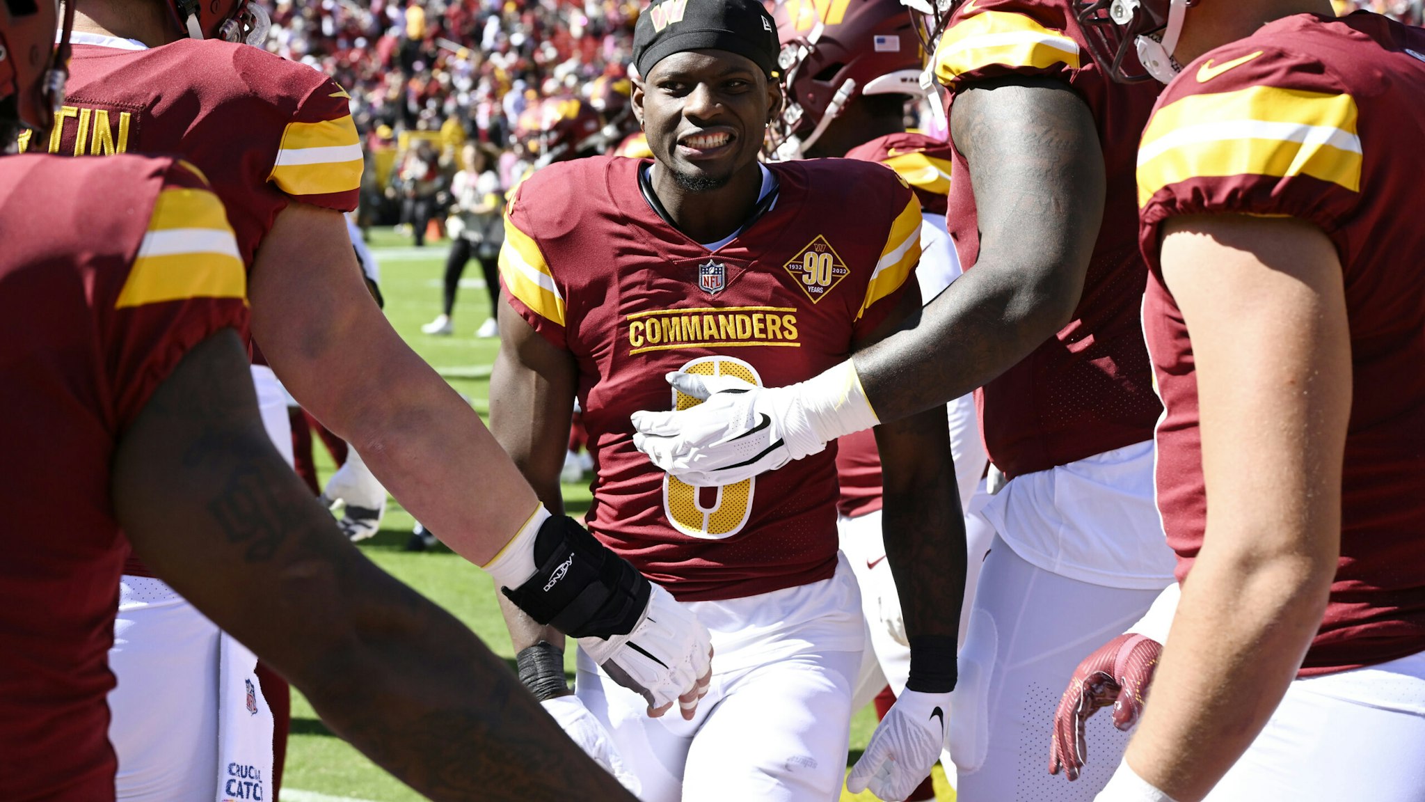 Brian Robinson #8 of the Washington Commanders reacts with teammates during pregame against the Tennessee Titans at FedExField on October 09, 2022 in Landover, Maryland.