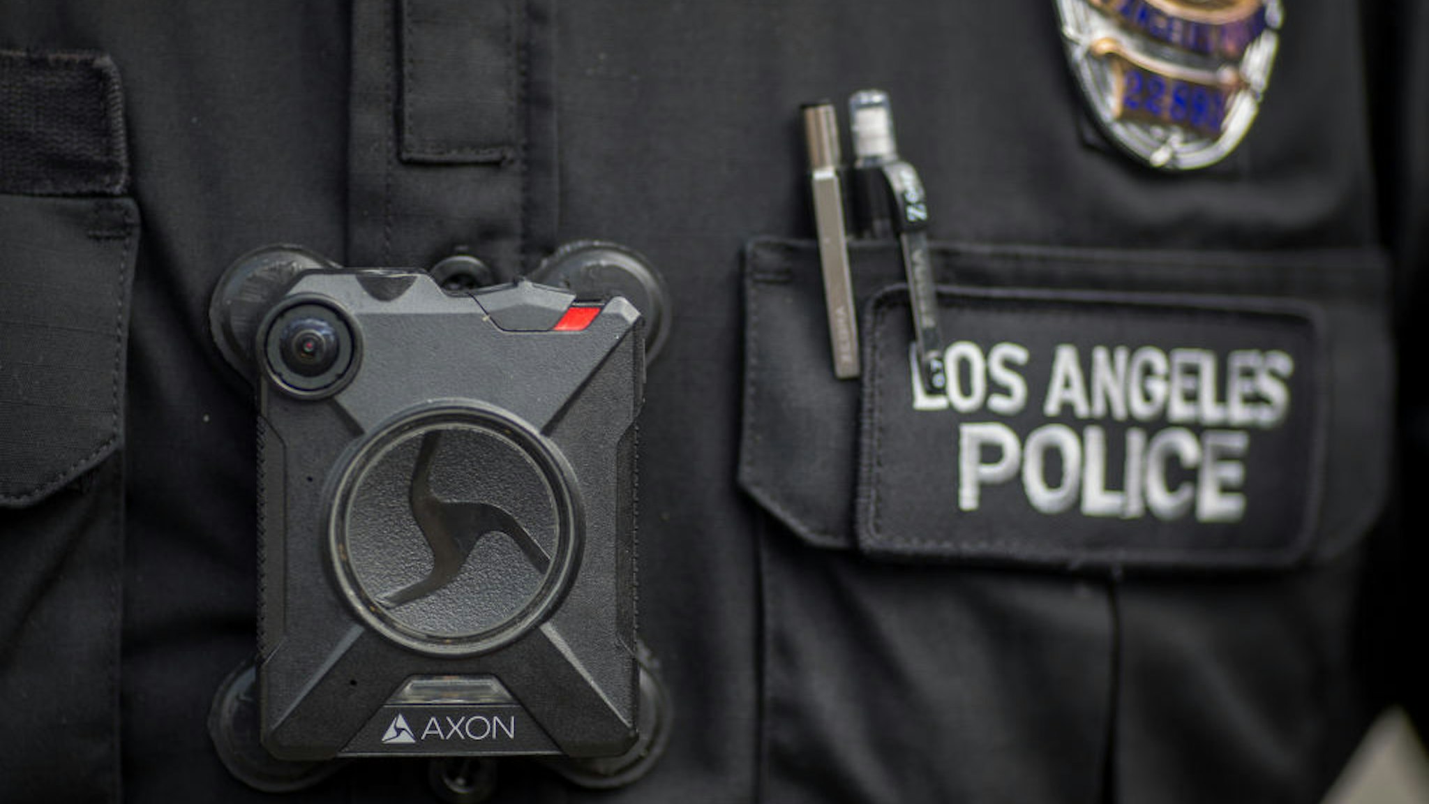 LOS ANGELES, CA - FEBRUARY 18: A Los Angeles police officer wear an AXON body camera during the Immigrants Make America Great March to protest actions being taken by the Trump administration on February 18, 2017 in Los Angeles, California. Protesters are calling for an end to stepped up ICE raids and deportations, and that health care be provided for documented and undocumented people. (Photo by David McNew/Getty Images)