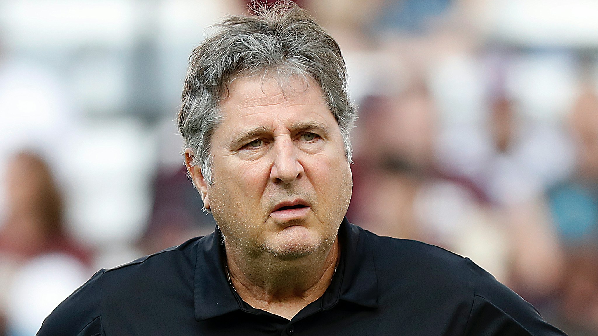 Head coach Mike Leach of the Mississippi State Bulldogs watches his playeres warm up before playing the Texas A&M Aggies at Kyle Field on October 02, 2021 in College Station, Texas.