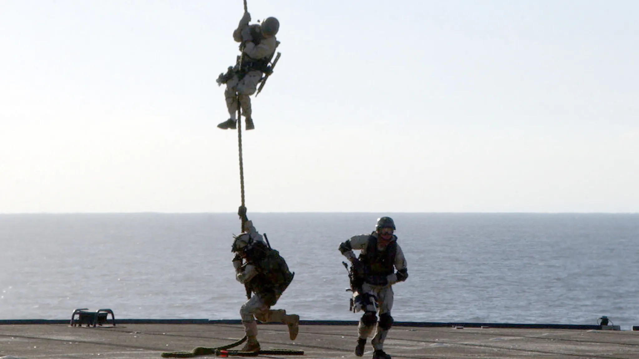 Navy SEAL-2 A U.S. Navy SEAL (SEa, Air, and Land) rappels from an MH-53 "Pave Low" helicopter to the deck of the amphibious command ship USS Mount Whitney during a training exercise January 17, 2003 while at sea.