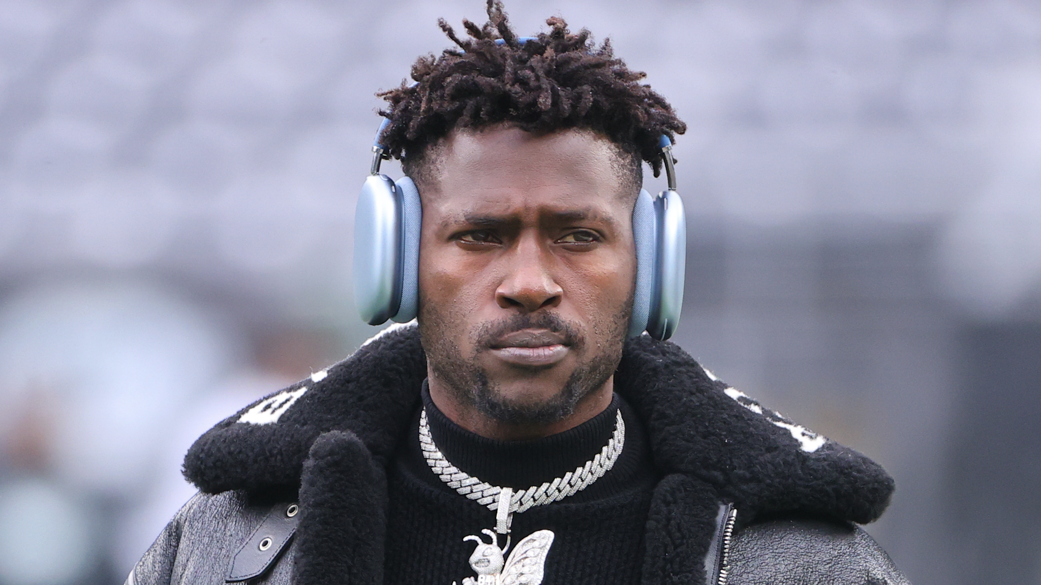 EAST RUTHERFORD, NJ - JANUARY 02: Tampa Bay Buccaneers wide receiver Antonio Brown (81) on the field in a Balenciaga jacket and a diamond Bee necklace prior to the National Football League game between the New York Jets and the Tampa Bay Buccaneers on January 2, 2022 at MetLife Stadium in East Rutherford, NJ.