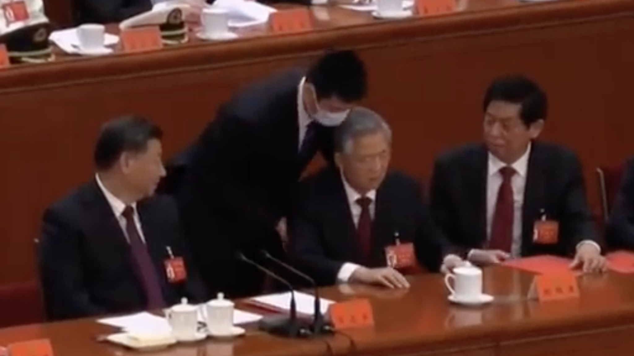 Hu Jintao, who preceded Xi as president of China from 2003-2013, looked confused and even angry as he was unexpectedly hauled away from the closing ceremony the ruling Communist Party congress. The 79-year-old former leader touched Xi’s shoulder and the two appeared to exchange words, but the current president seemed unmoved.