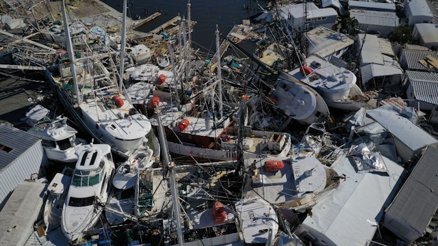 In this aerial view, boats sit atop one another in a marina near Fort Myers Beach on September 29, 2022 in San Carlos Island, Florida.