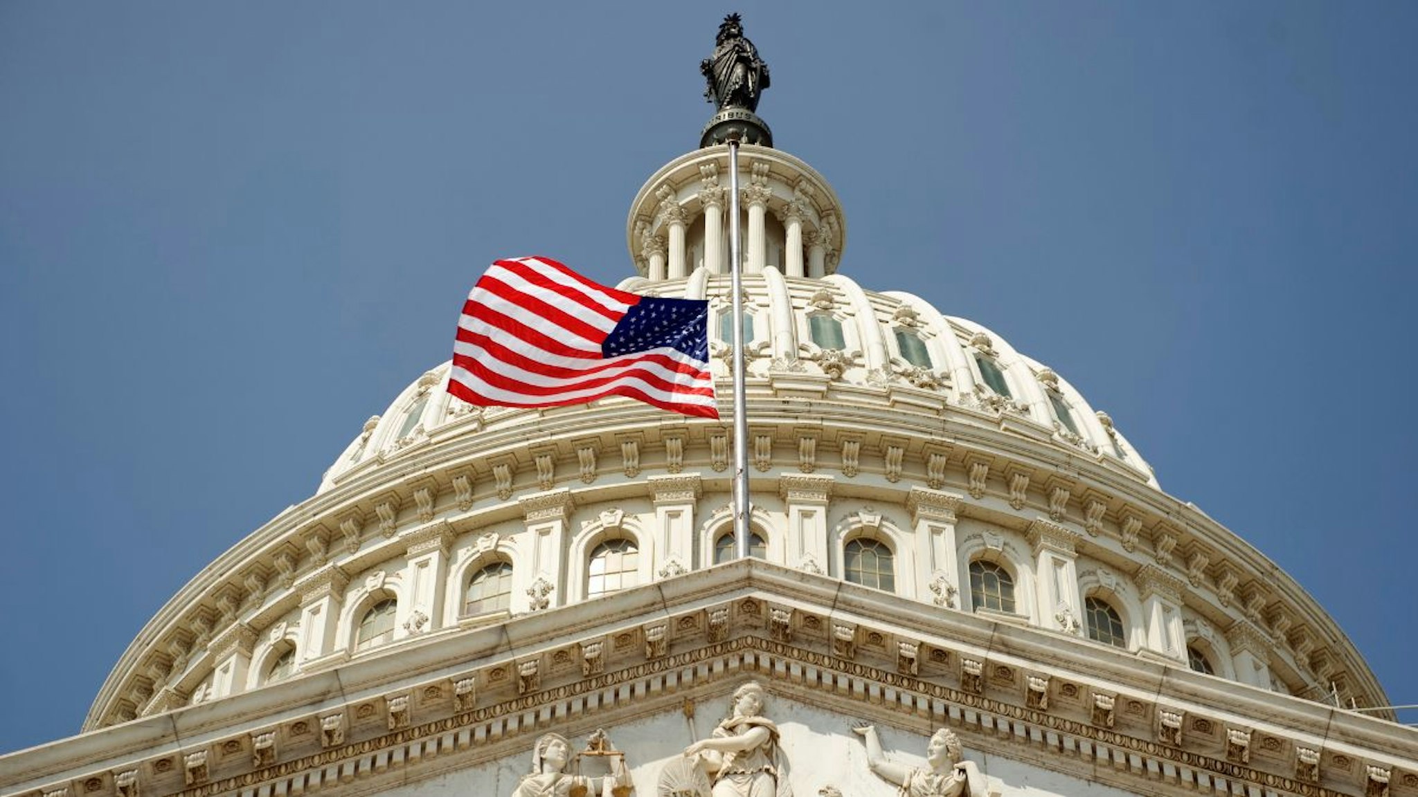 An American flag on the east front of the Capitol files at mast in honor of the late Senator Ted Stevens who died in a plane crash in Alaska Monday.