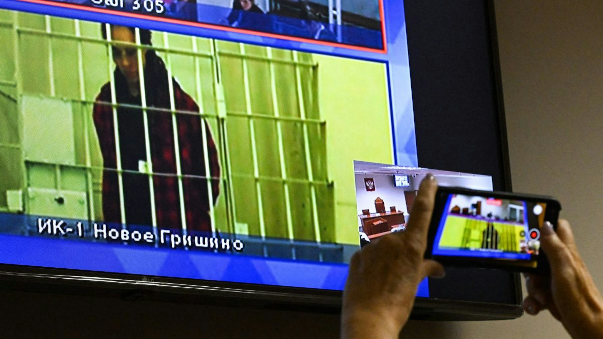 US basketball player Brittney Griner, who was sentenced to nine years in a Russian penal colony in August for drug smuggling, is seen on a screen via a video link from a remand prison during a court hearing to consider an appeal against her sentence, at the Moscow regional court on October 25, 2022.