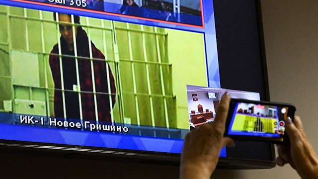 US basketball player Brittney Griner, who was sentenced to nine years in a Russian penal colony in August for drug smuggling, is seen on a screen via a video link from a remand prison during a court hearing to consider an appeal against her sentence, at the Moscow regional court on October 25, 2022.