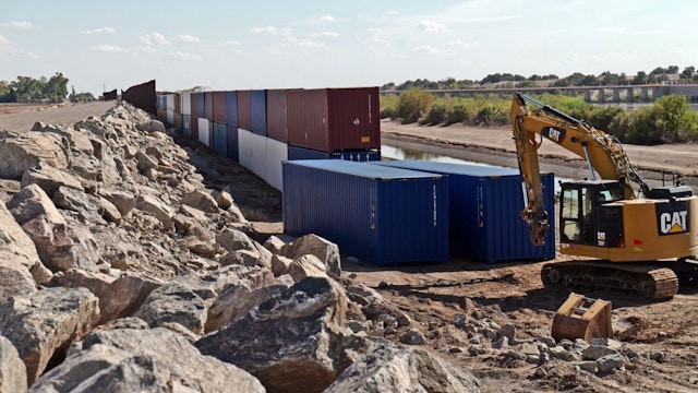 Shipping containers block a void in the wall as that prevent migrants attempting to cross in to the U.S. from Mexico at the border August 19, 2022 in San Luis, Arizona.
