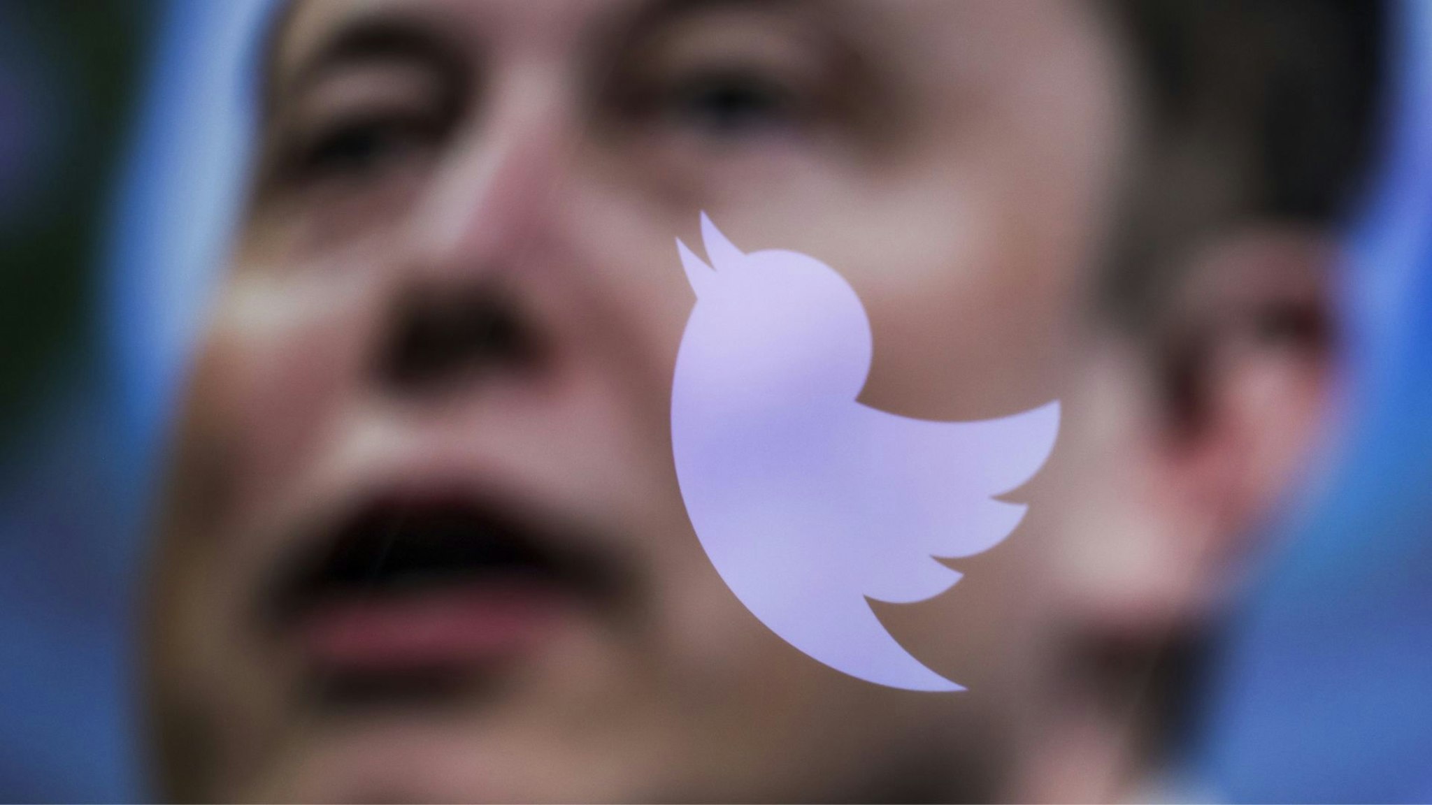 ANKARA, TURKIYE - OCTOBER 06: In this photo illustration, the image of Elon Musk is displayed on a computer screen and the logo of twitter is reflected in Ankara, Turkiye on October 06, 2022.