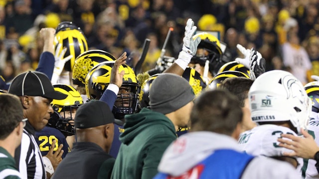 Michigan players wave goodbye to Michigan State players as they exit the field at the end of a college football game between the Michigan State Spartans and the Michigan Wolverines on October 29, 2022 at Michigan Stadium in Ann Arbor, Michigan.