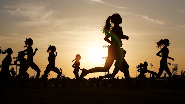 Runners compete in a 5k at sunset in Corona, California. - stock photo Runners compete in a 5k at sunset in Corona, California. K.C. Alfred via Getty Images