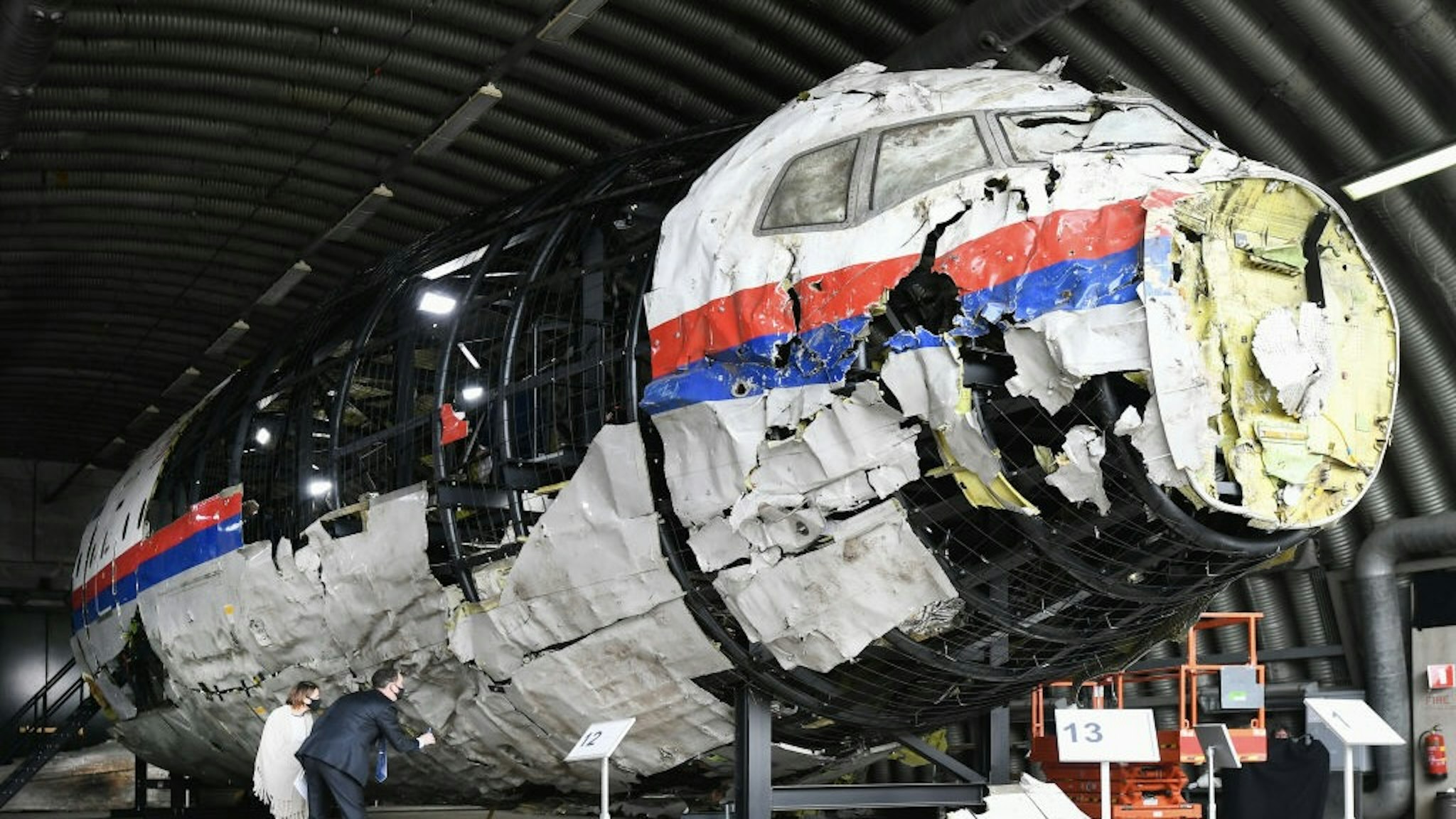 Judges View Flight MH-17 Wreckage Ahead Of Next Trial Phase REIJEN, NETHERLANDS - MAY 26: Lawyers attend the judges' inspection of the reconstruction of the MH17 wreckage, as part of the murder trial ahead of the beginning of a critical stage, on May 26, 2021 in Reijen, Netherlands. Judges and lawyers viewed the wreckage of Malaysian Airlines Flight 17, a commercial flight between Kuala Lumpur and the Netherlands that was shot down over Ukraine in 2014, ahead of a new phase in the trial of three Russians and a Ukrainian suspect. All 283 passengers and 15 crew members were killed. (Photo by Piroschka van de Wouw - Pool/Getty Images) Pool / Pool