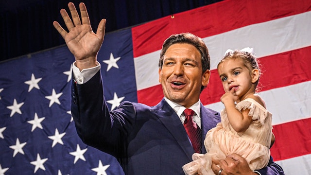 Republican gubernatorial candidate for Florida Ron DeSantis holds his daughter Mamie during an election night watch party at the Convention Center in Tampa, Florida, on November 8, 2022. - Florida Governor Ron DeSantis, who has been tipped as a possible 2024 presidential candidate, was projected as one of the early winners of the night in Tuesday's midterm election.