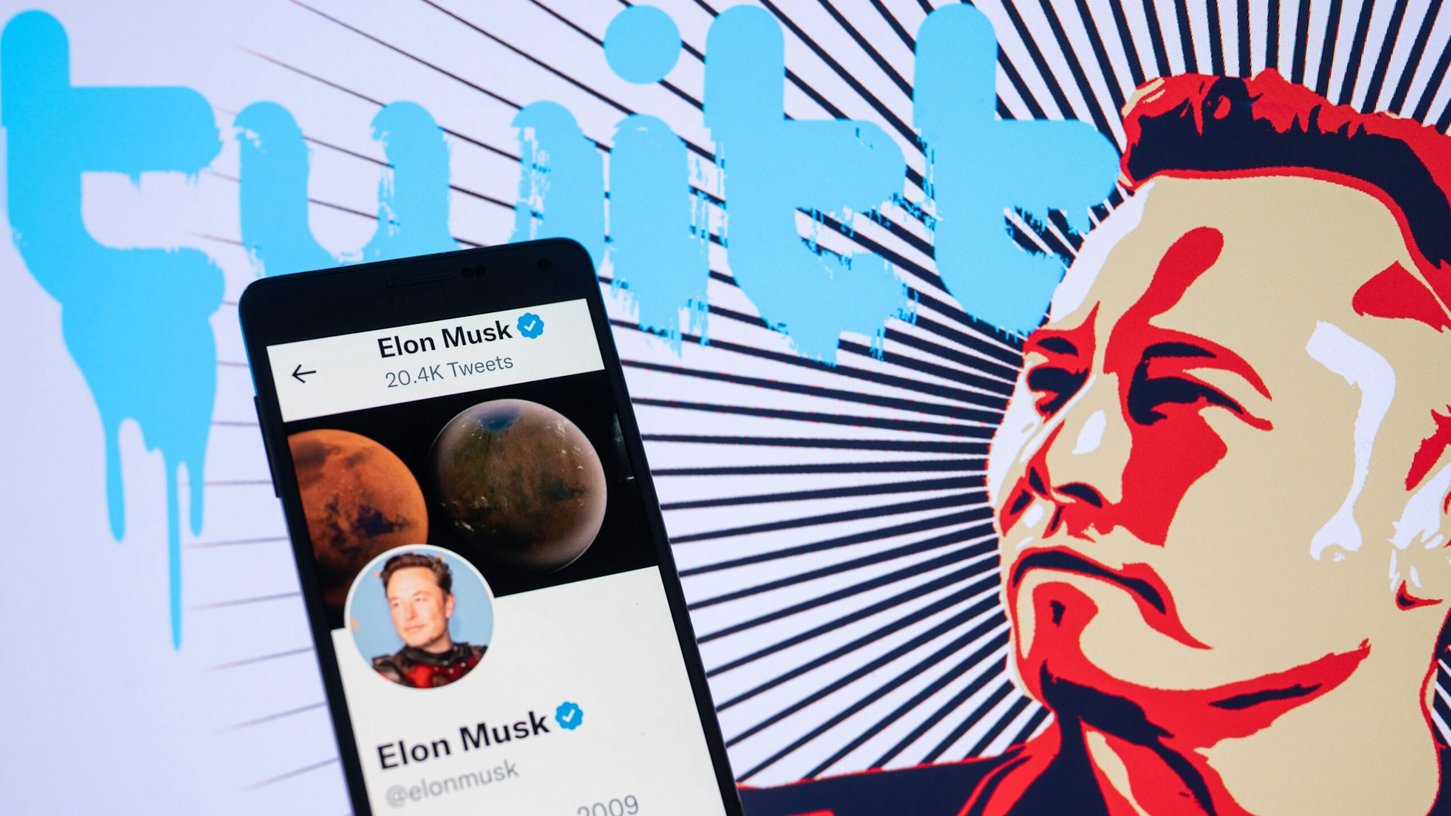Elon Musk's Twitter account displayed on a mobile with Elon Musk in the background are seen in this illustration. In Brussels - Belgium on 19 November 2022.