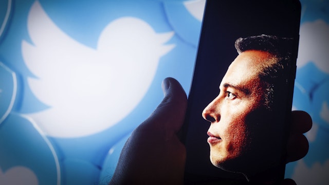 Elon Musk along with the Twitter logo is seen in this illustration photo in Warsaw, Poland on 12 November, 2022. The option to sign up for Twitters new verification service for $7.99 has disappeared from the iOS app after users were abusing it to impersonate brands and famous people.