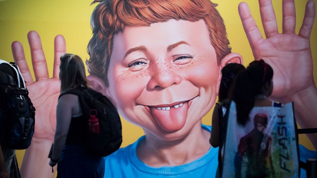 SAN DIEGO, CA - JULY 20: The face of Alfred E. Neuman frames greets attendees at the DC booth during the first day of Comic-Con International at the San Diego Convention Center in San Diego, CA on Thursday, July 20, 2017. (Photo by