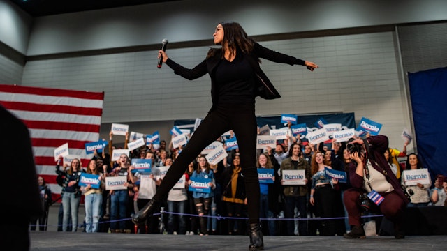 SIOUX CITY, IOWA - JANUARY 26: Alexandria Ocasio-Cortez, D-N.Y., dances on the stage ahead of Sen. Bernie Sanders, I-Vt., 2020 Democratic Presidential Candidate during a rally on Sunday, January 26, 2020 in Sioux City, Iowa. (Photo by