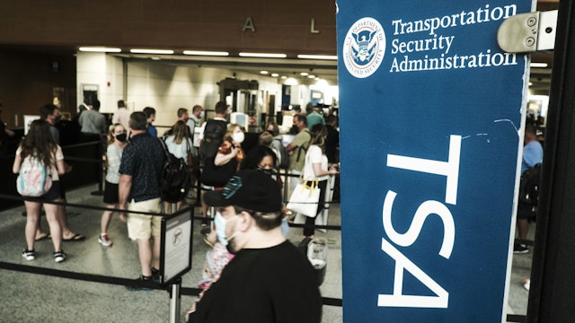 Travelers make their way through the Transportation Security Administration (TSA) checkpoint at the Detroit Metropolitan Wayne County Airport (DTX) in Romulus, Michigan, U.S., on Saturday, June 12, 2021. The acting head of the TSA is reportedly warning that 131 of the largest airports in the U.S. will likely face staffing shortages this month, as air travel begins to pick up amid the nation's Covid-19 recovery. Photographer: Matthew Hatcher/Bloomberg via Getty Images