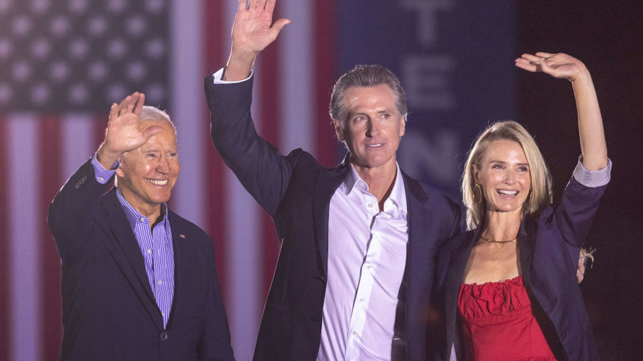 U.S. President Joe Biden, California Gov. Gavin Newsom and Jennifer Lynn Siebel Newsom wave to the crowd as they campaign to keep the governor in office at Long Beach City College on the eve of the last day of the special election to recall the governor on September 13, 2021 in Long Beach, California.