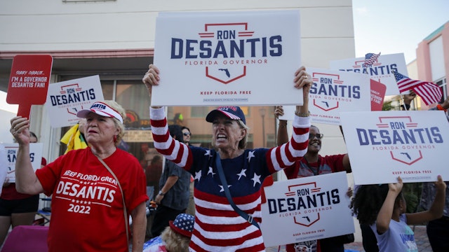 Supporters of Ron DeSantis, governor of Florida, hold signs ahead of the Florida gubernatorial debate in Fort Pierce, Florida, US, on Monday, Oct. 24, 2022.